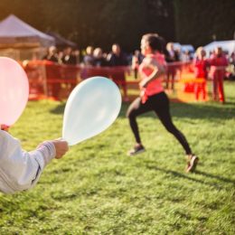 Supporter holding balloons at sports event