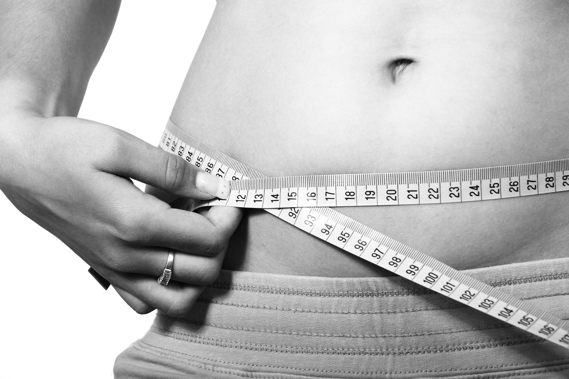 Woman measuring her waist.